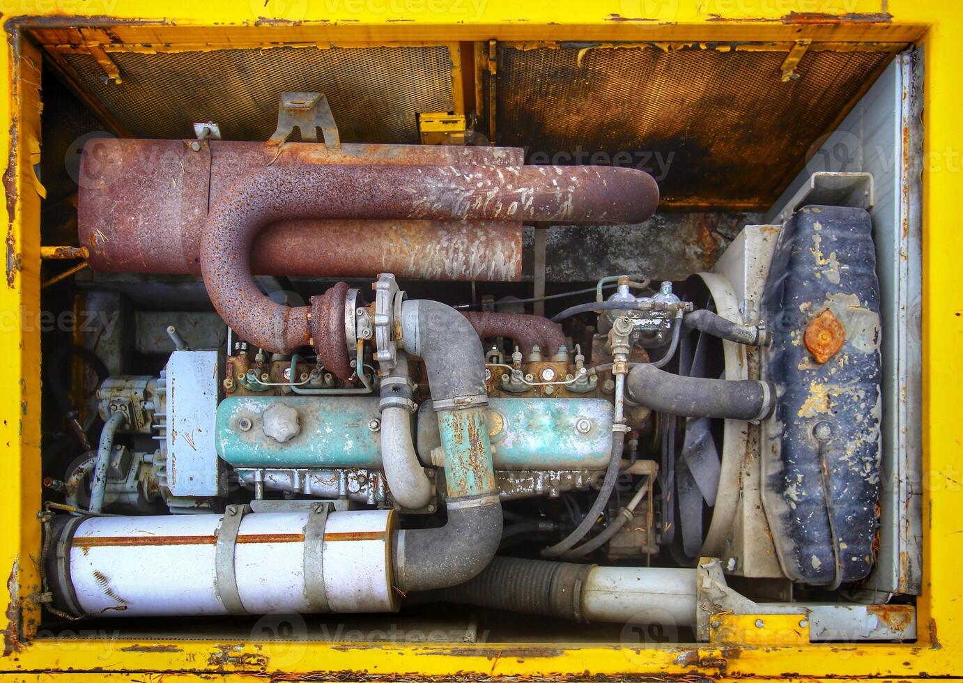 Engine bay of an old and rusty excavator photo