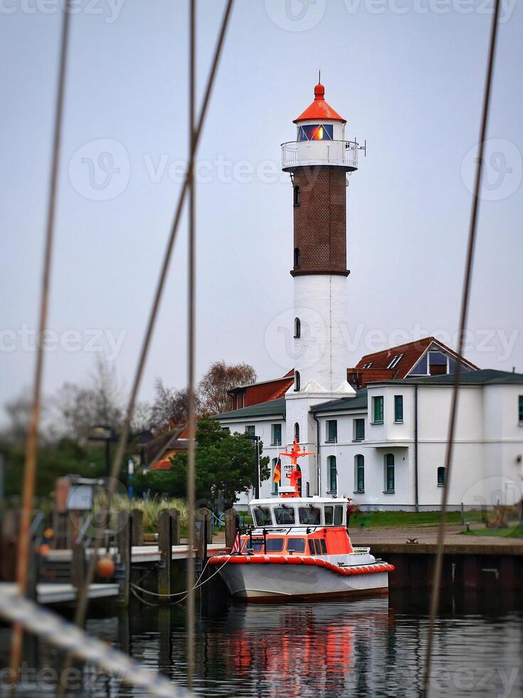 Port with lighthouse and defocused ropes in Timmendorf photo