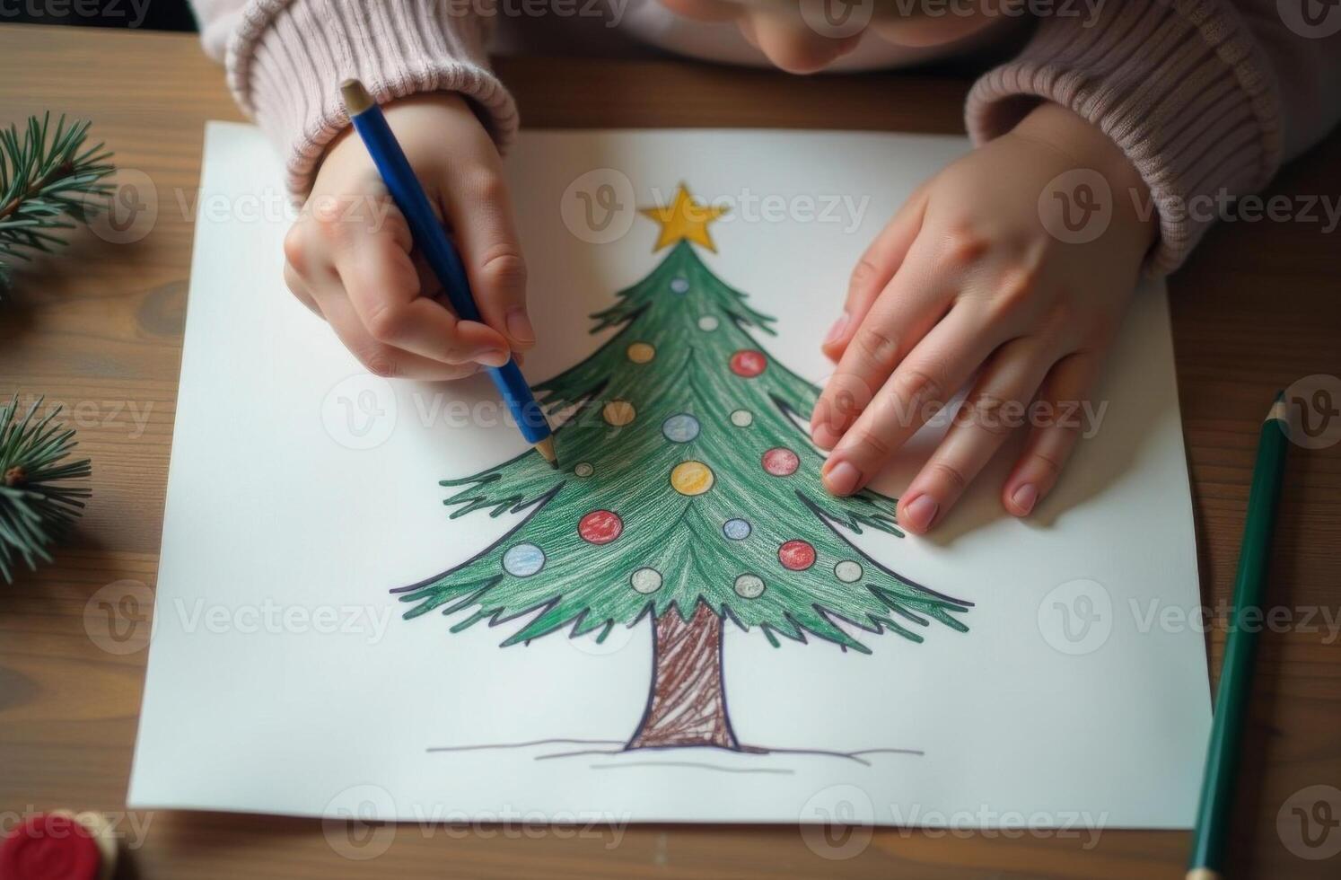 Child amusing draw decorate Christmas tree, New Year drawing, hand holding pencil, white sheet paper lies on table photo