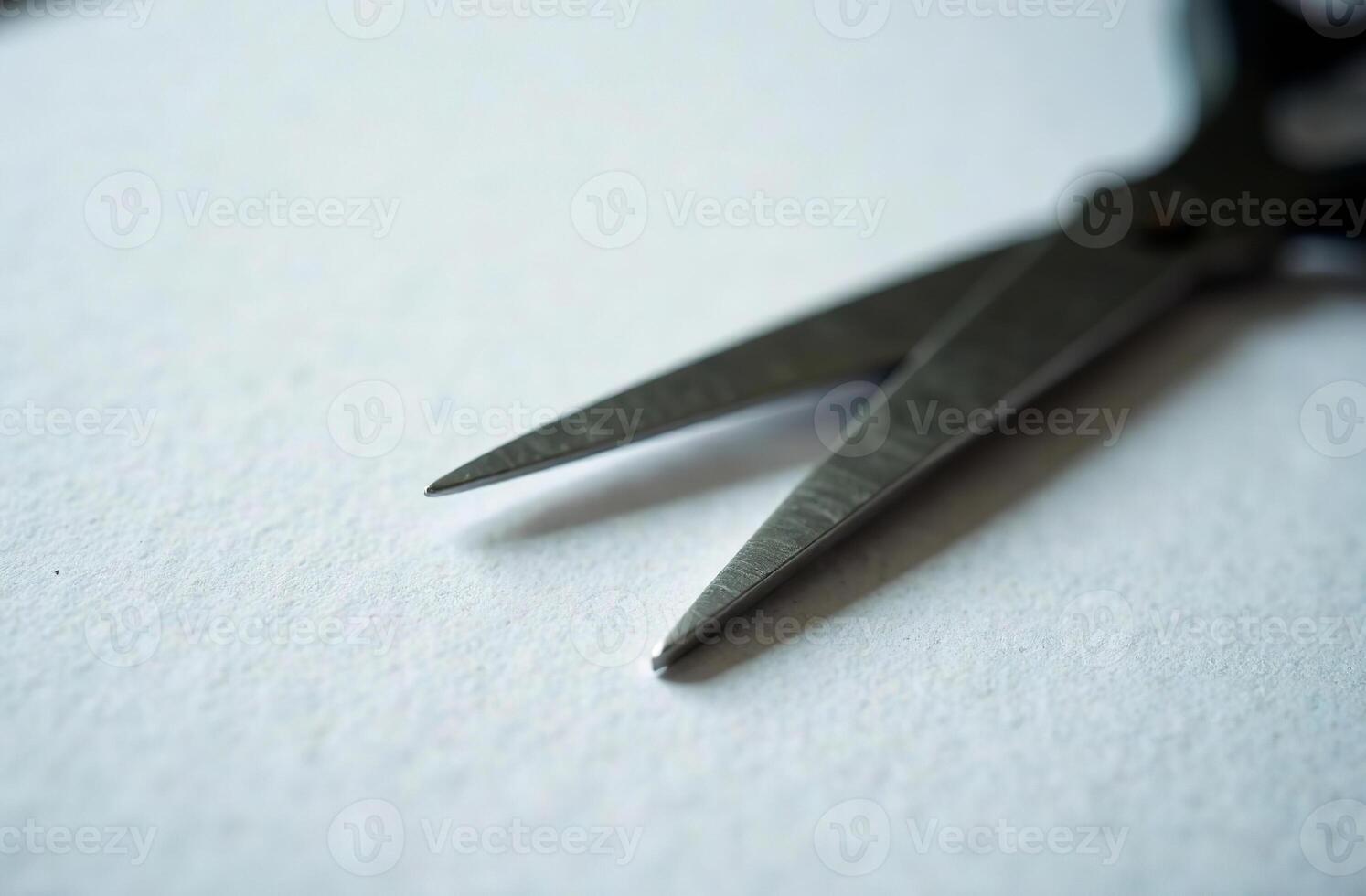 Scissors on white paper, workplace in office, student desk photo
