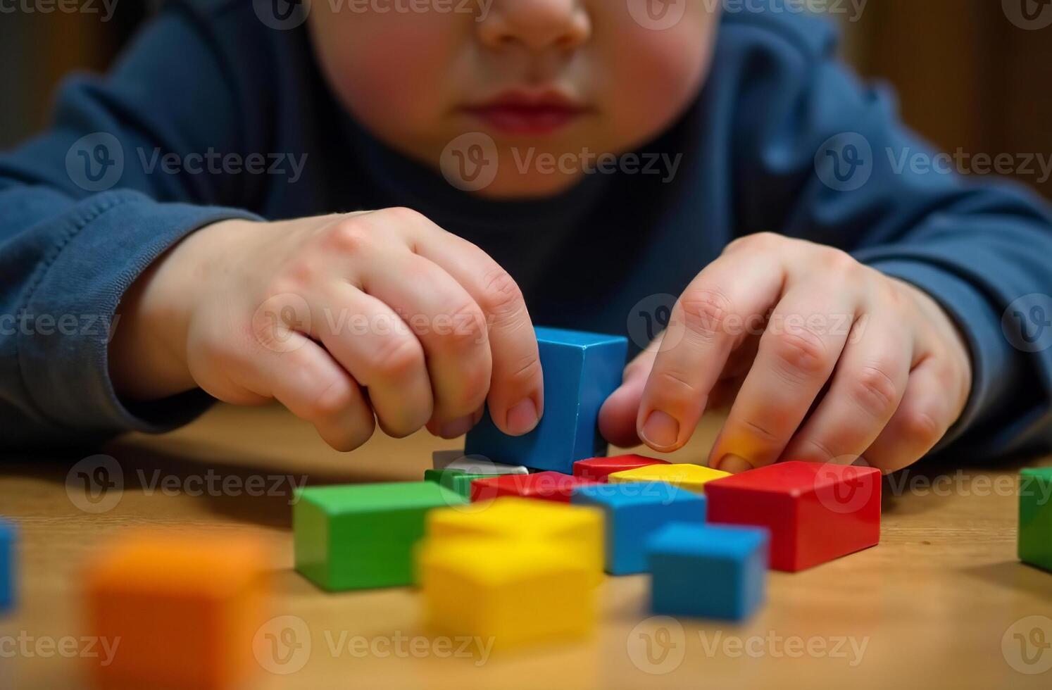 Child playing with children toy cubic blocks cool in the playroom photo