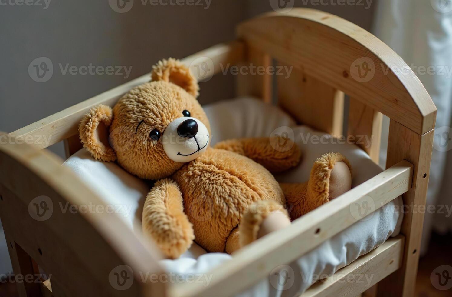 Teddy bear lying in crib, stuffed toy in children bedroom photo