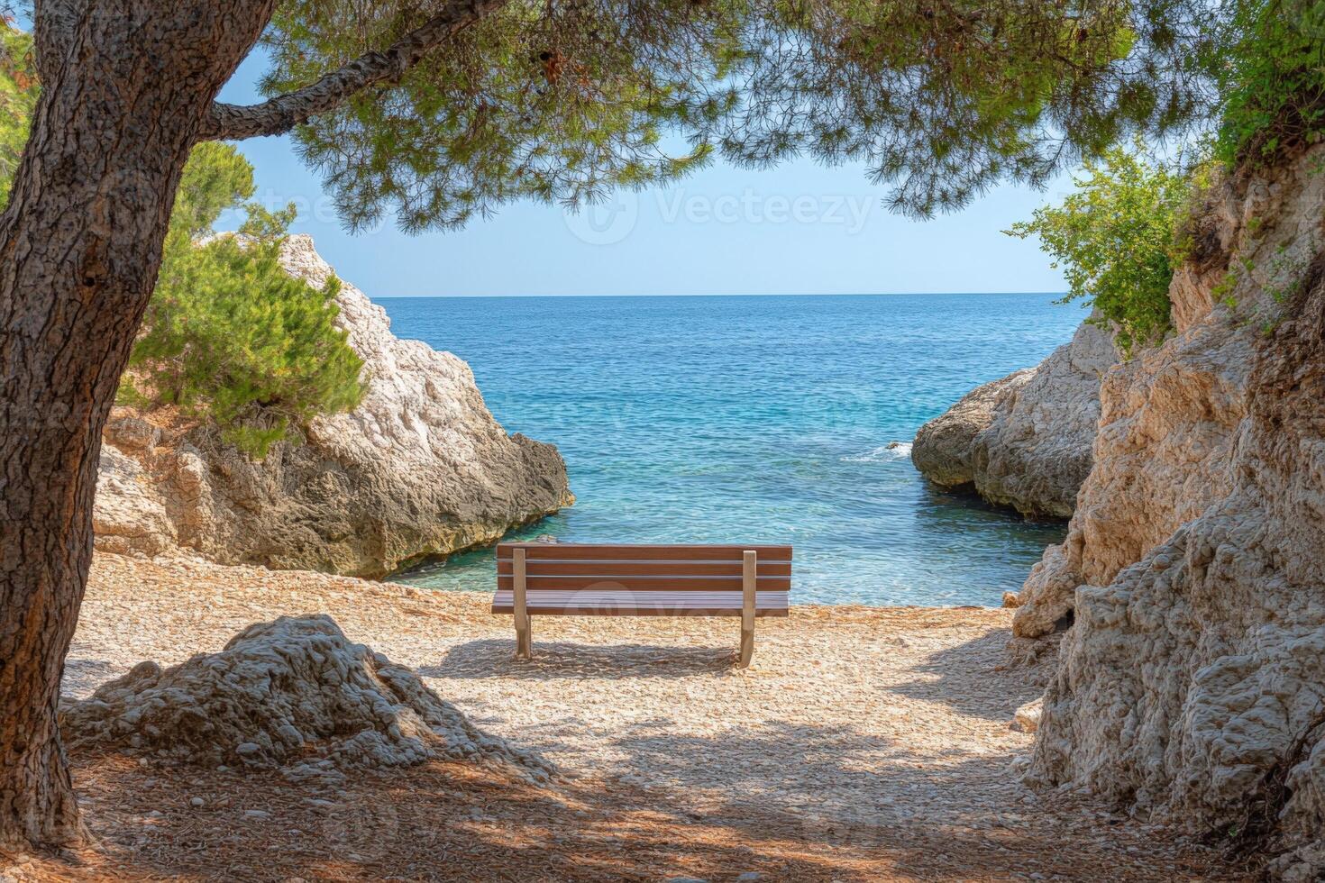 A bench sitting on a sandy beach next to a body of water photo