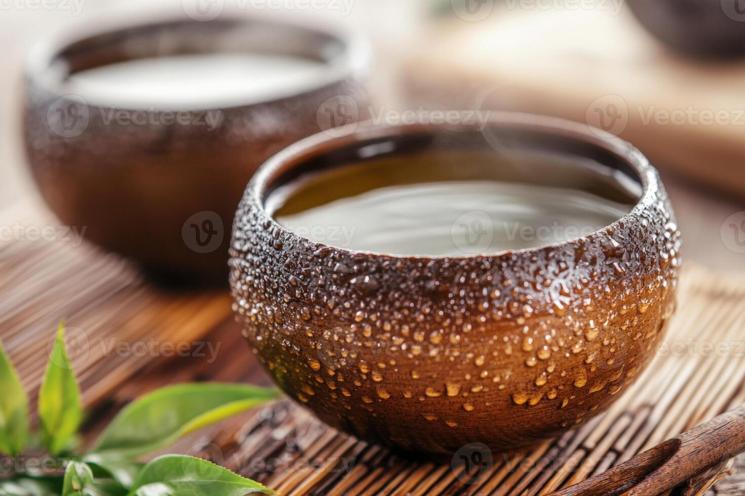 Two cups of tea with leaves and cinnamon photo