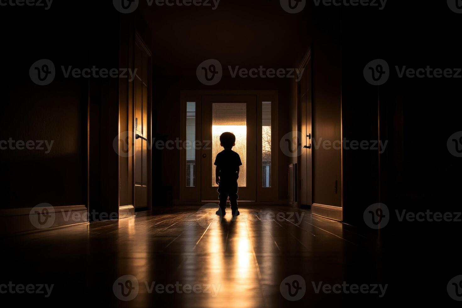 A silhouette of a child standing in a dark hallway photo