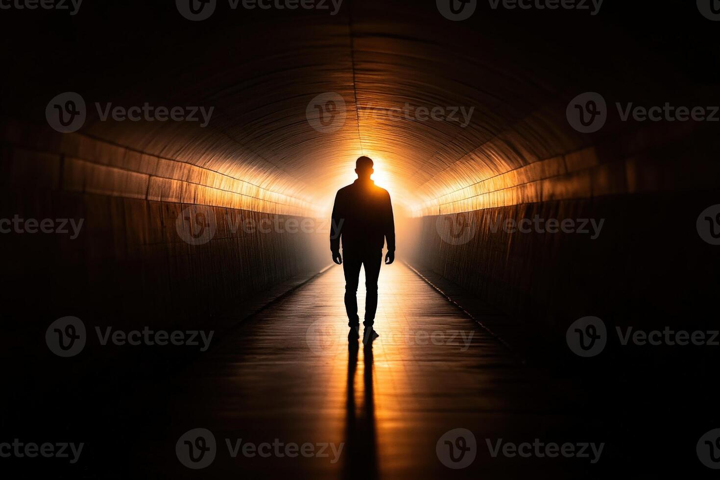 A man standing in the middle of a dark tunnel photo