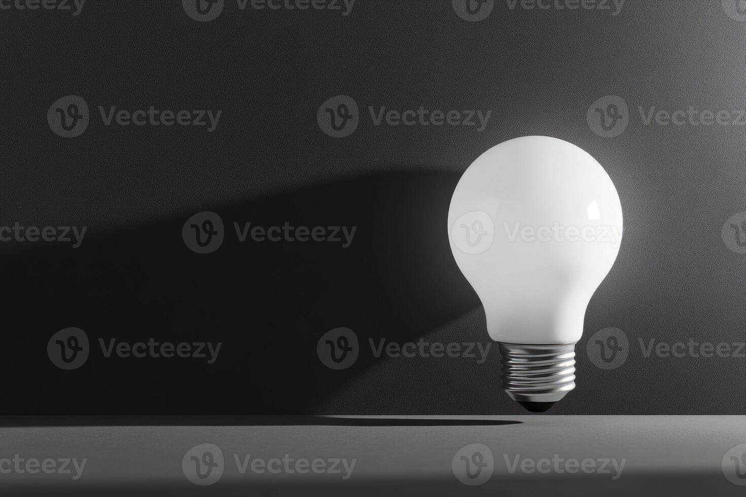 A Single Light Bulb on a Dark Surface photo