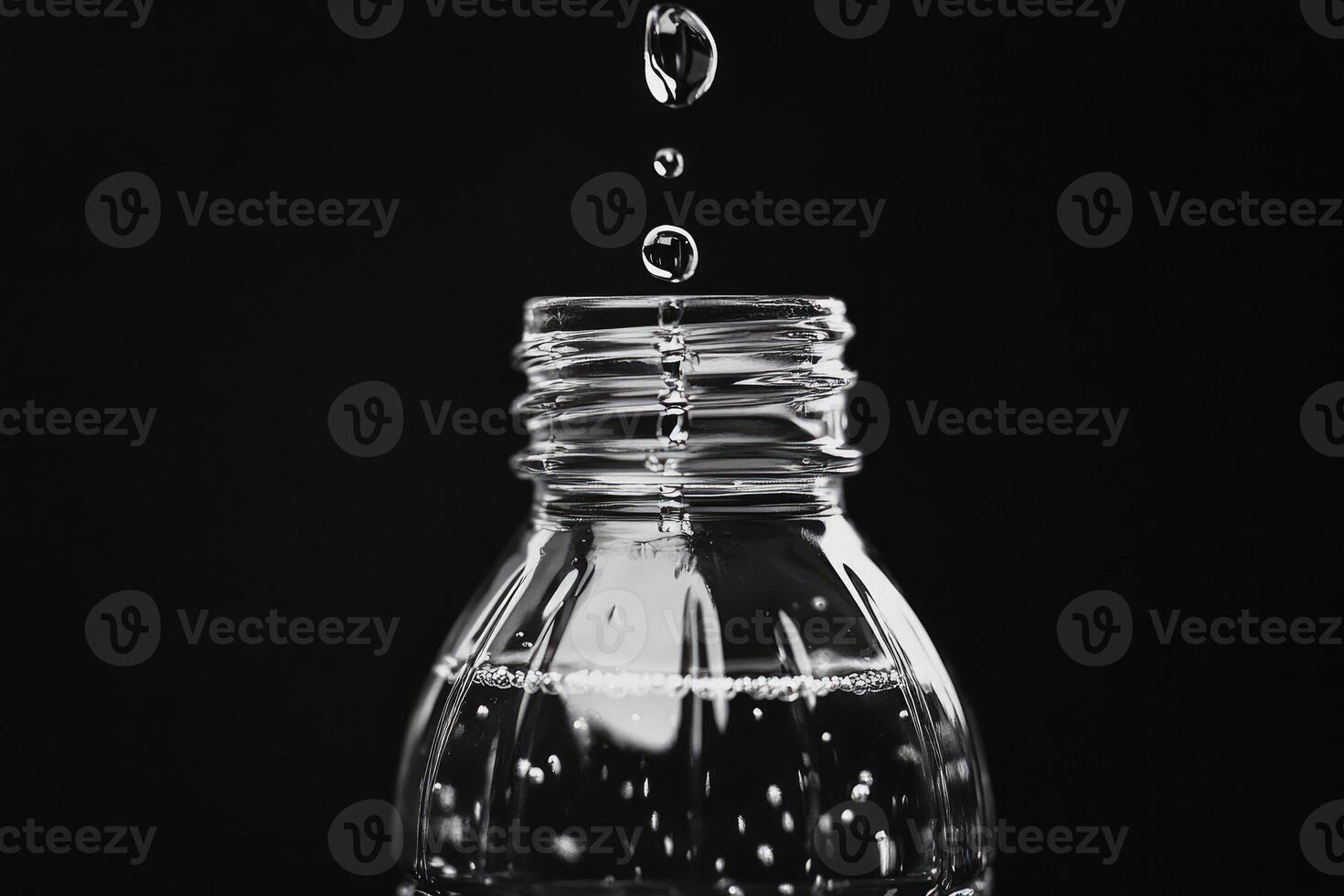 Water Droplets Falling Into a Water Bottle photo