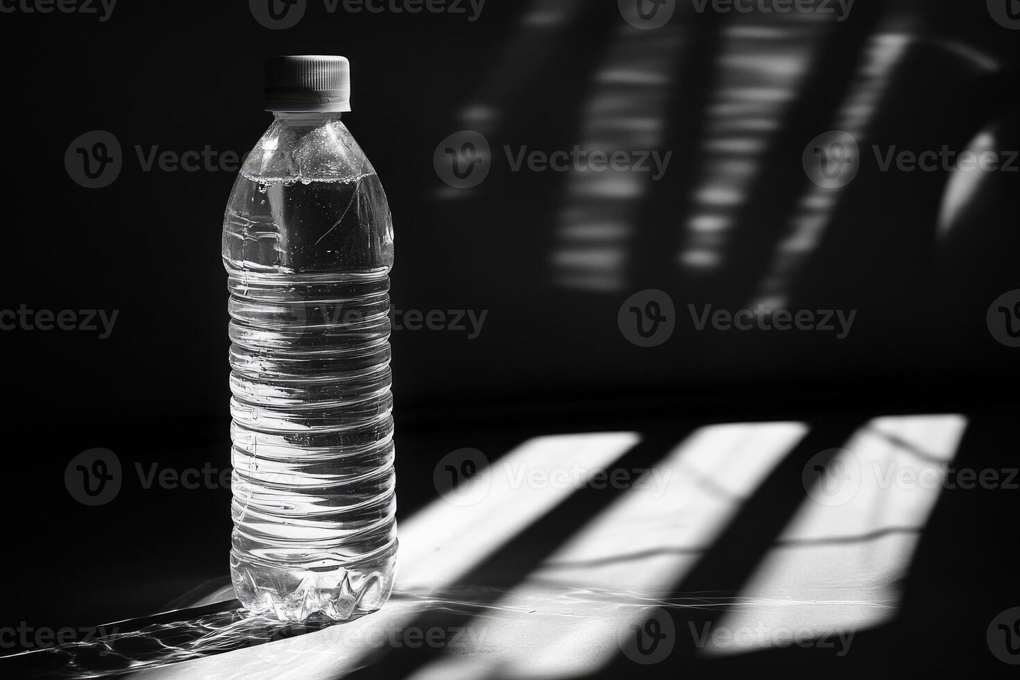 A Single Water Bottle with Shadows in a Dark Room photo