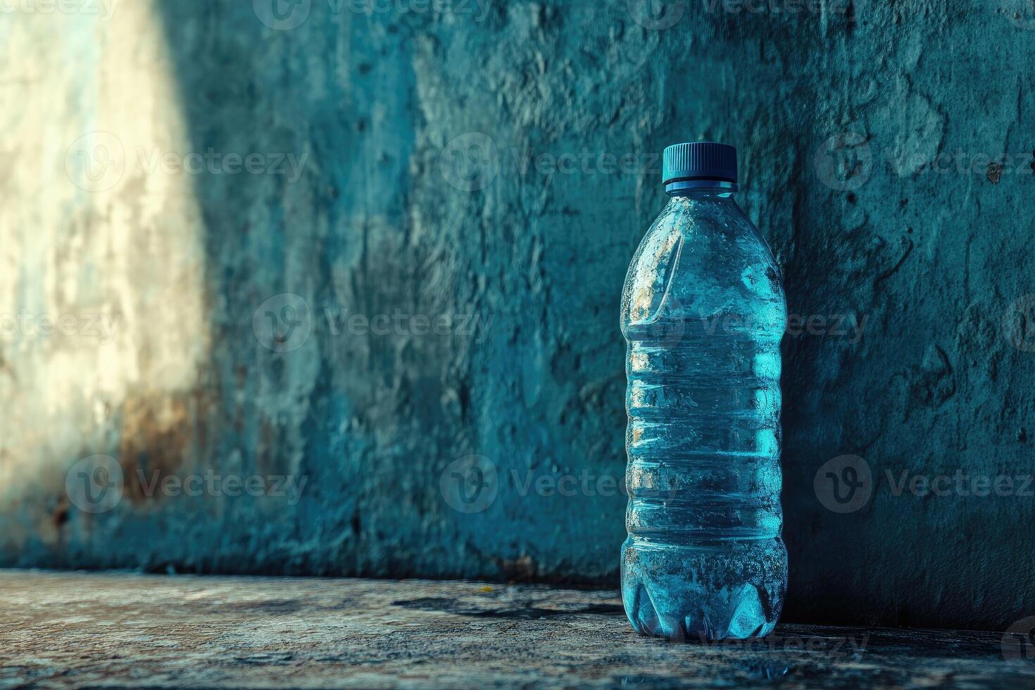 A Single Water Bottle on a Concrete Surface with a Blue-Toned Background photo
