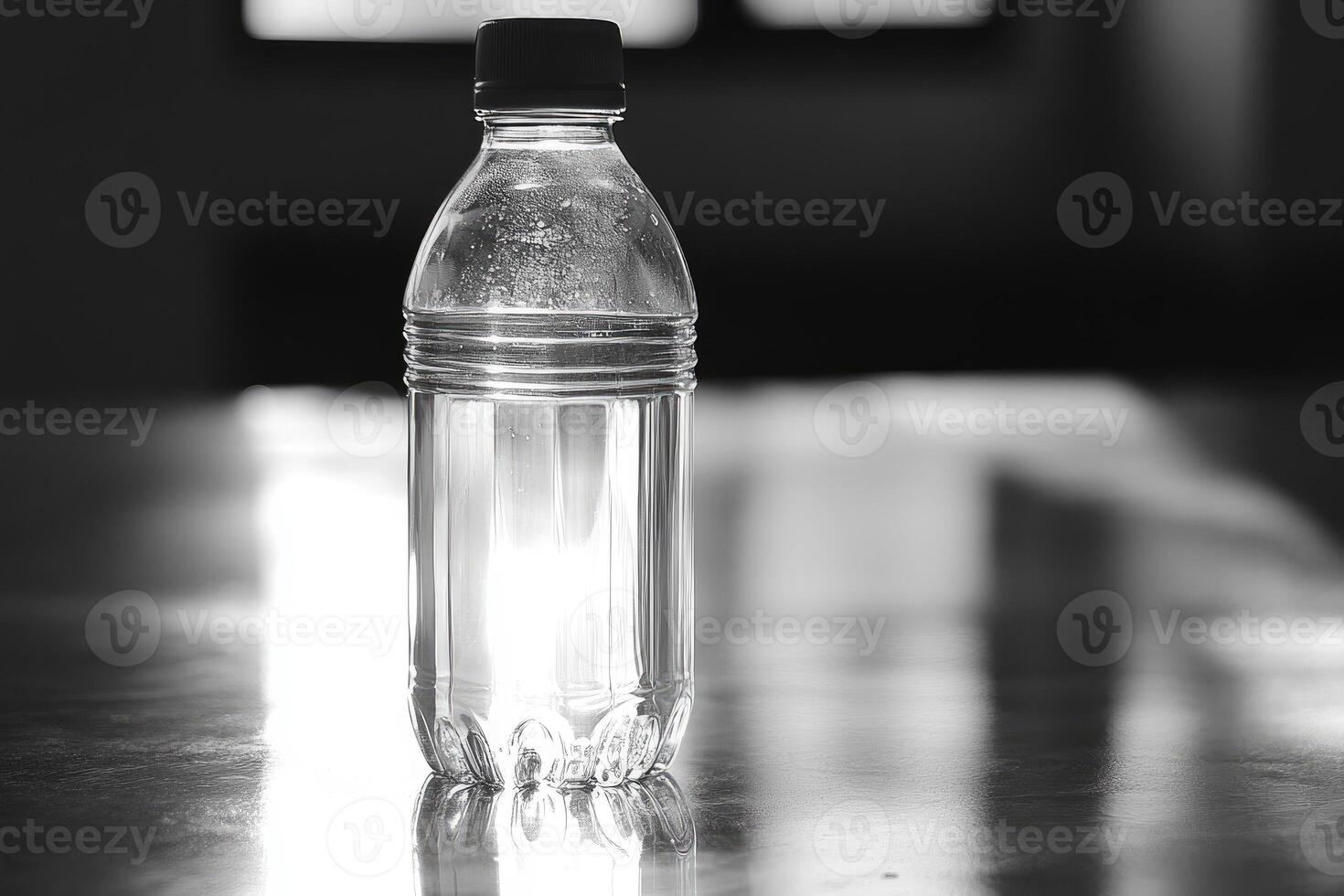 A Single, Transparent Plastic Water Bottle on a Reflective Surface photo