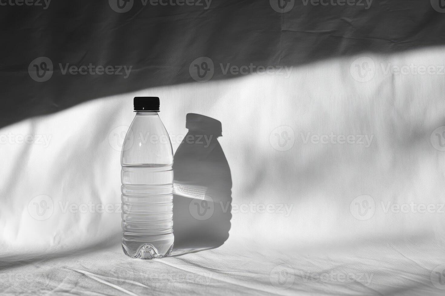 A Single Water Bottle with a Shadow Cast on a White Surface photo