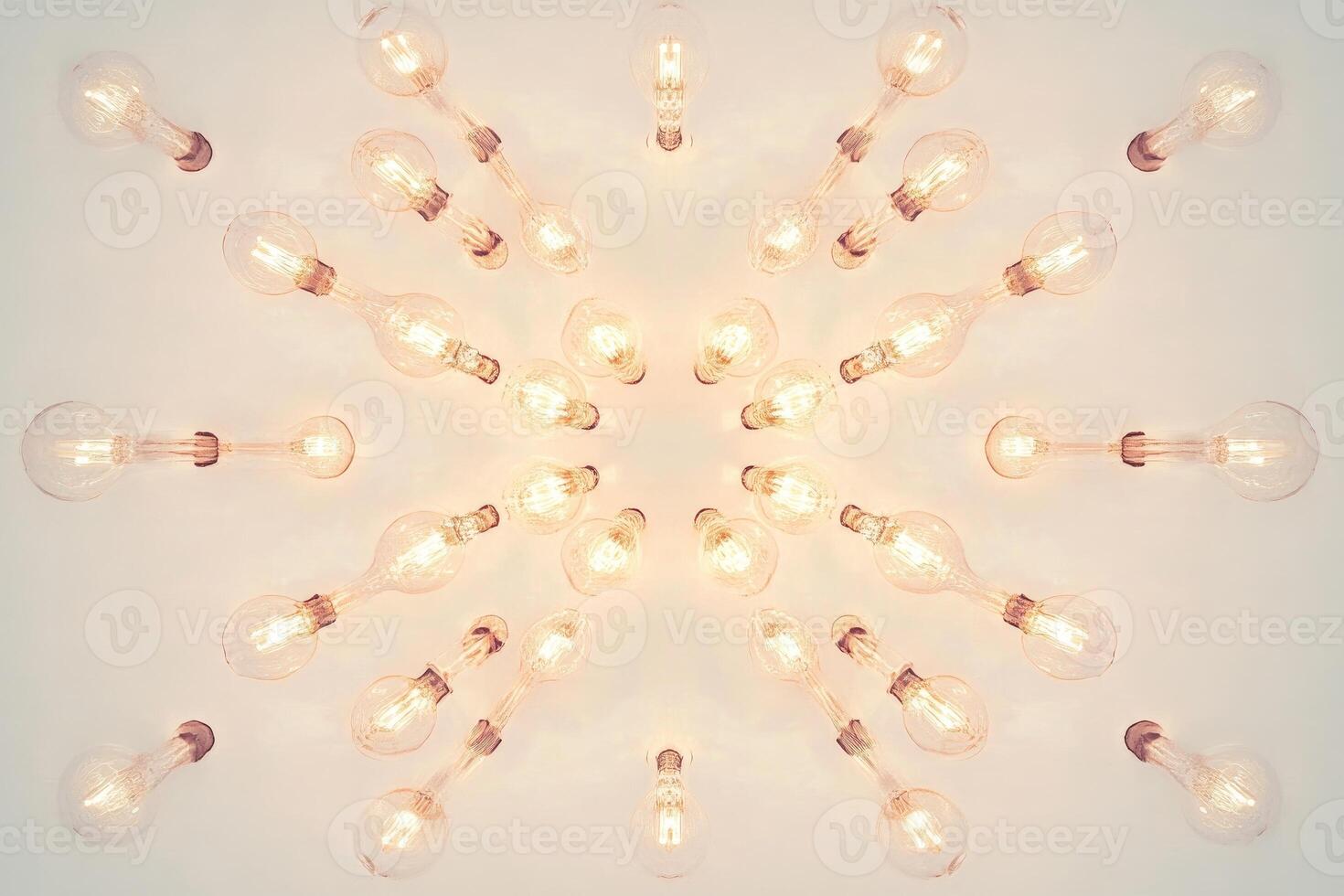 A Symmetrical Array of Glowing Light Bulbs on a White Ceiling photo