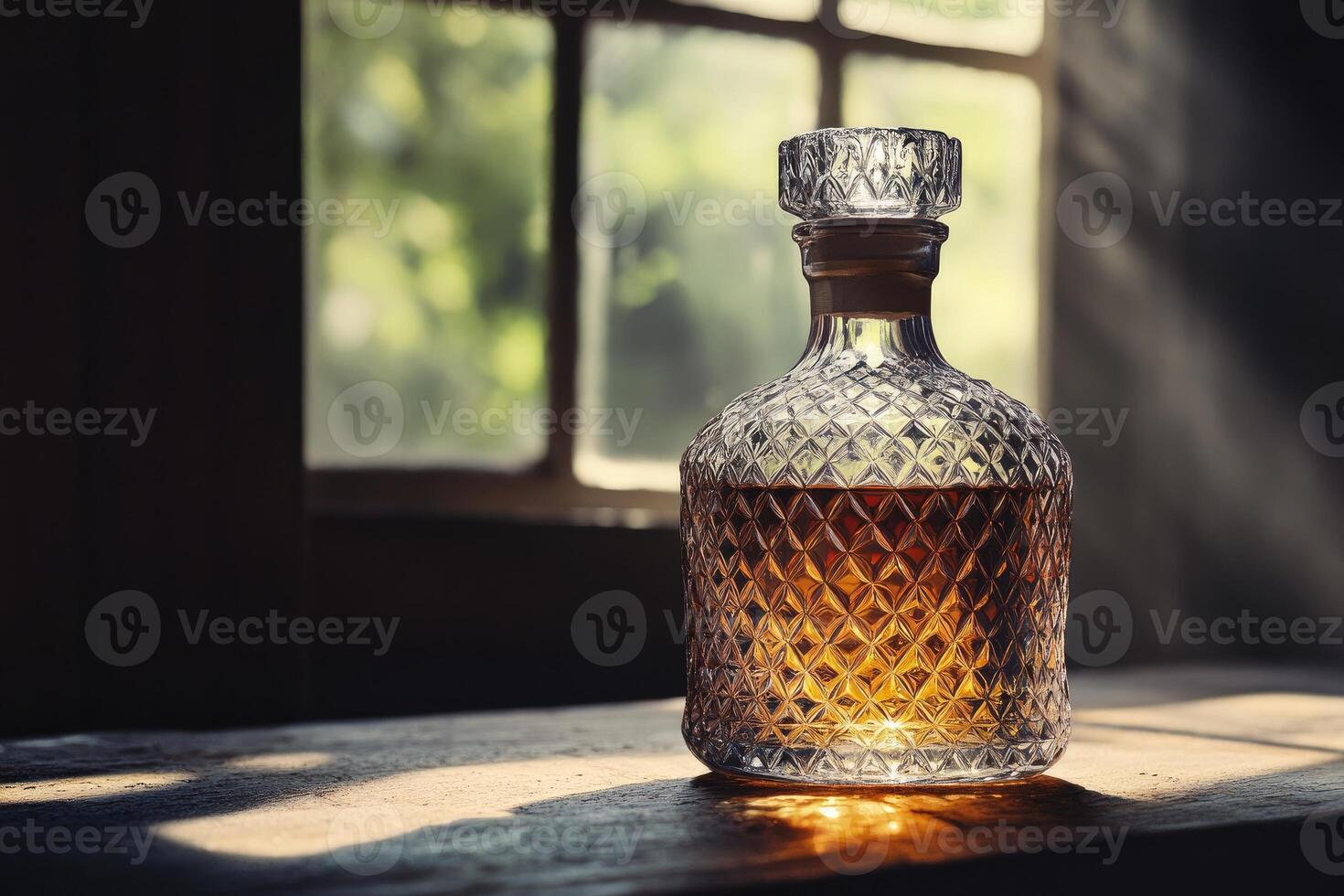 Crystal Decanter of Amber Liquid on Wooden Surface with Sunlight Streaming Through a Window photo