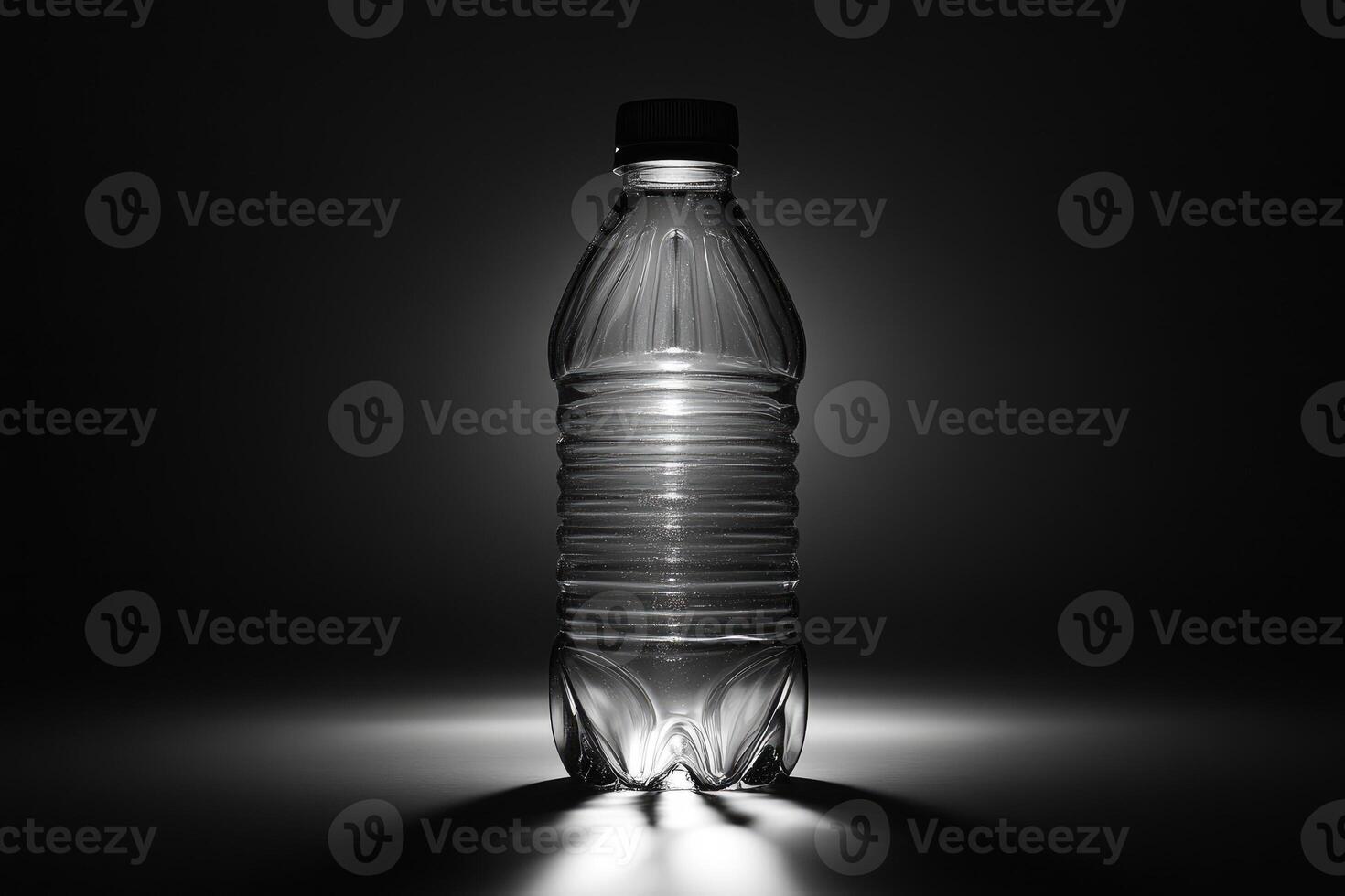 A Clear Plastic Water Bottle With a Black Cap Standing on a Gray Surface photo