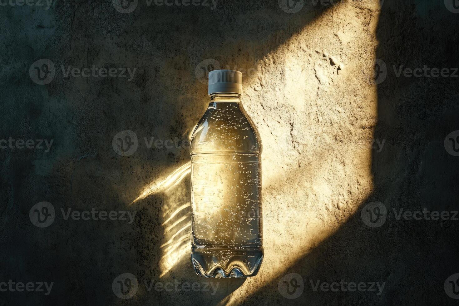 A Single Plastic Bottle of Water on a Rough, Textured Wall with Sunbeams photo