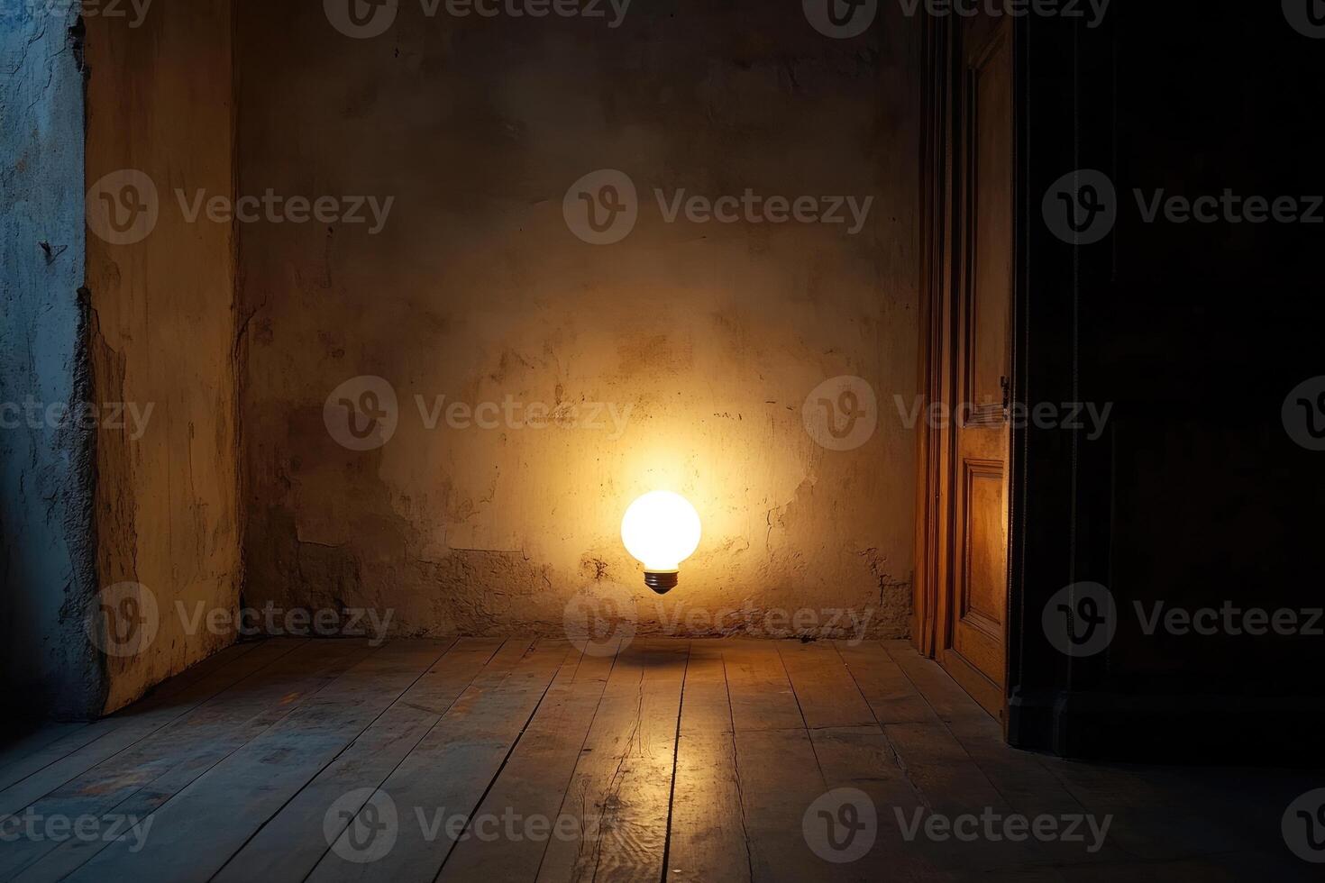 A Single Lightbulb Illuminates a Dark Room with Rough Walls and a Wooden Doorway photo