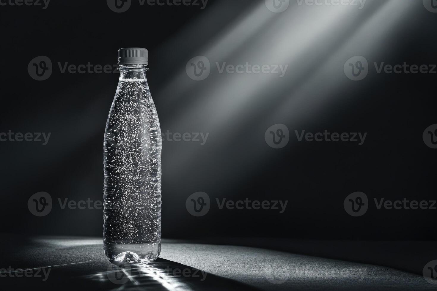 A single bottle of sparkling water in a dark environment with a spotlight photo