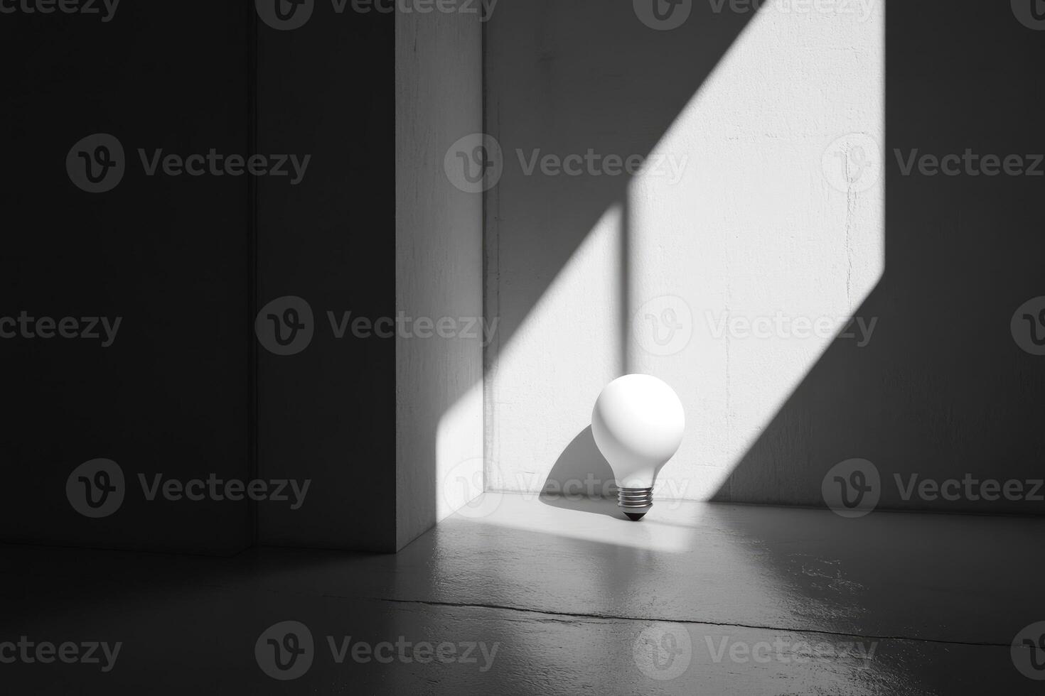 A Single White Lightbulb on a Gray Floor with Sunlight Streaming Through a Window photo