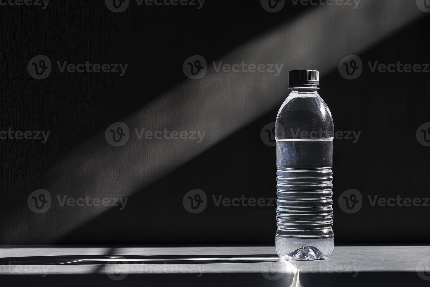 A Single Water Bottle in a Dramatic Light Setting photo