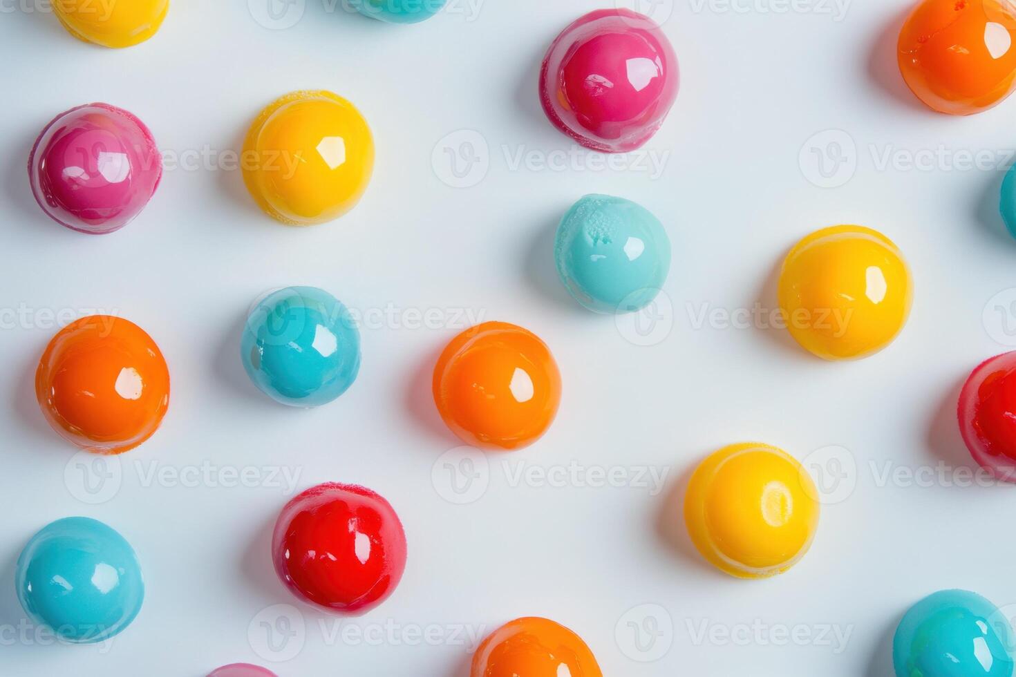 Colorful glossy spherical candies arranged on white background photo