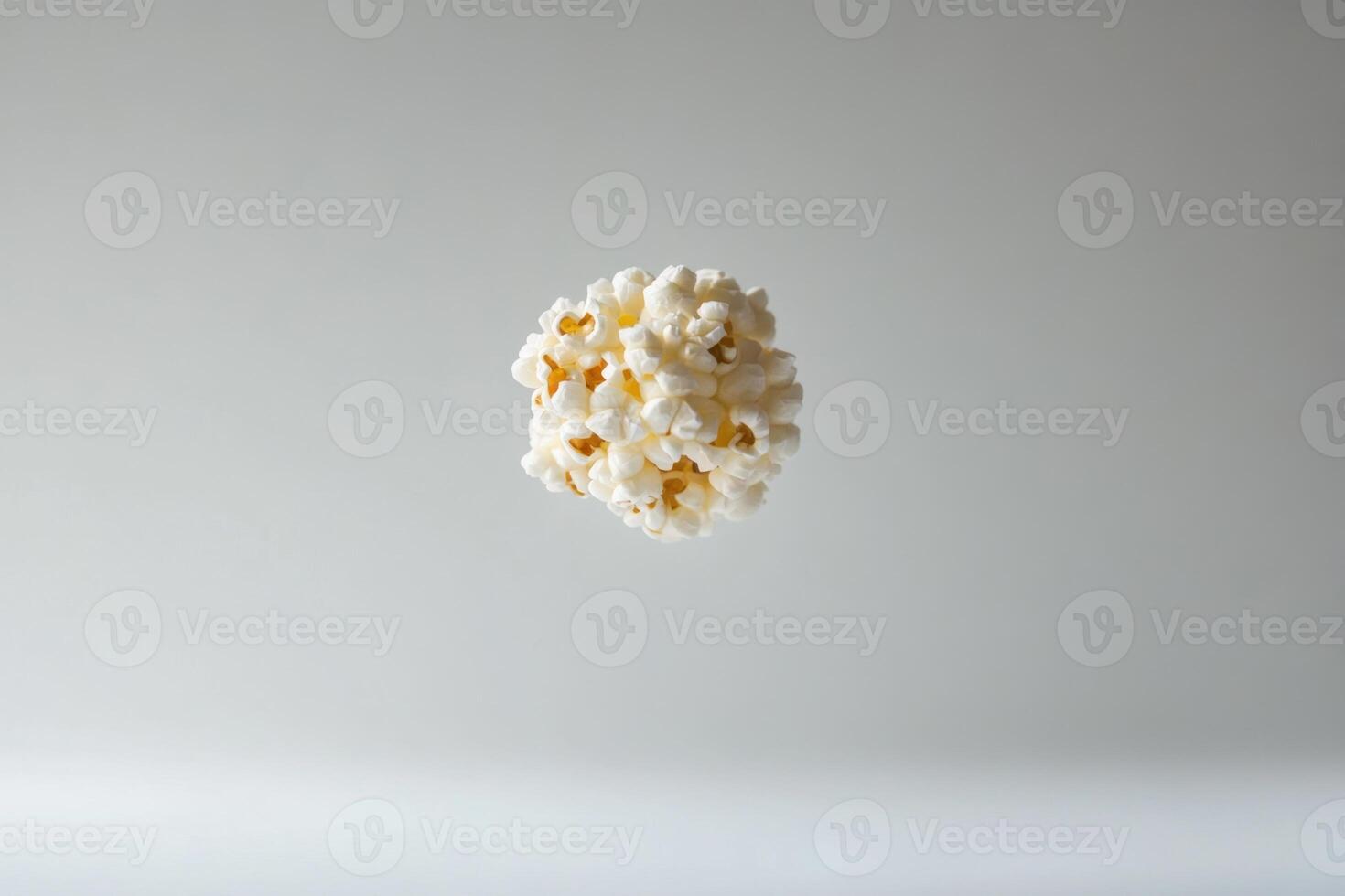 A spherical cluster of popcorn floats against a neutral background photo