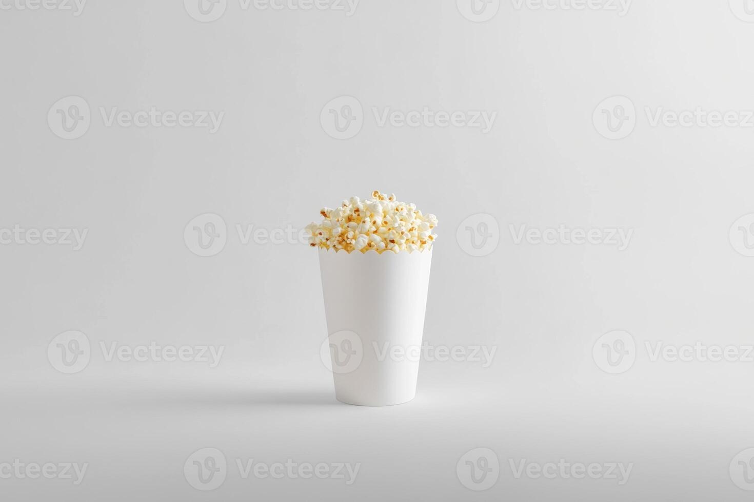 A White Cup Filled With Popcorn Snacks photo