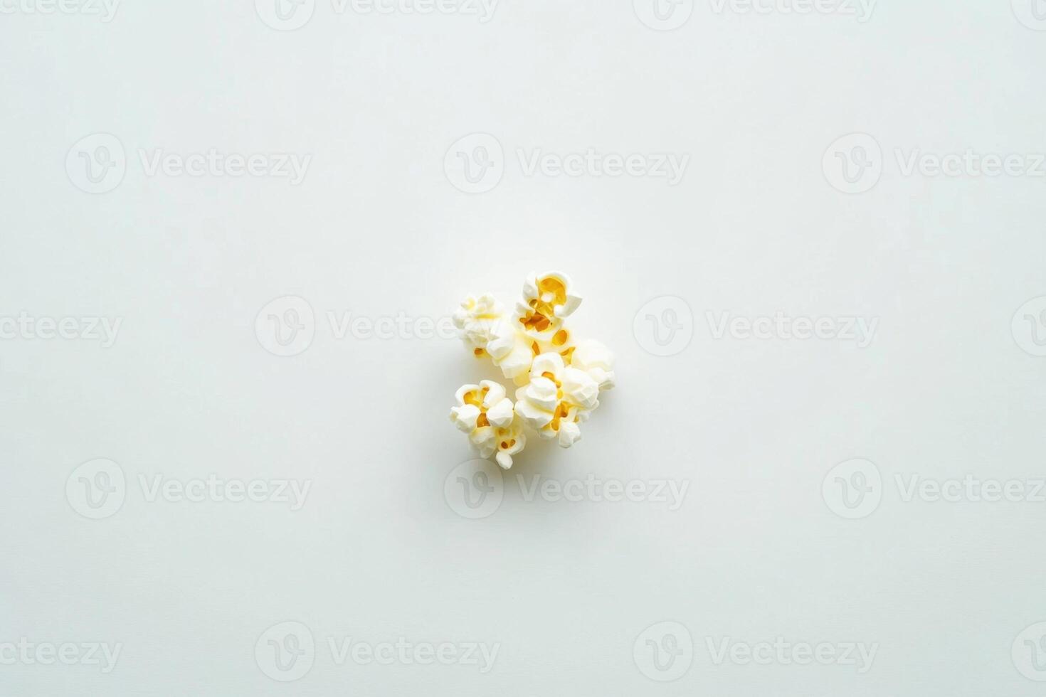 A Small Cluster Of Popcorn Kernels On White photo