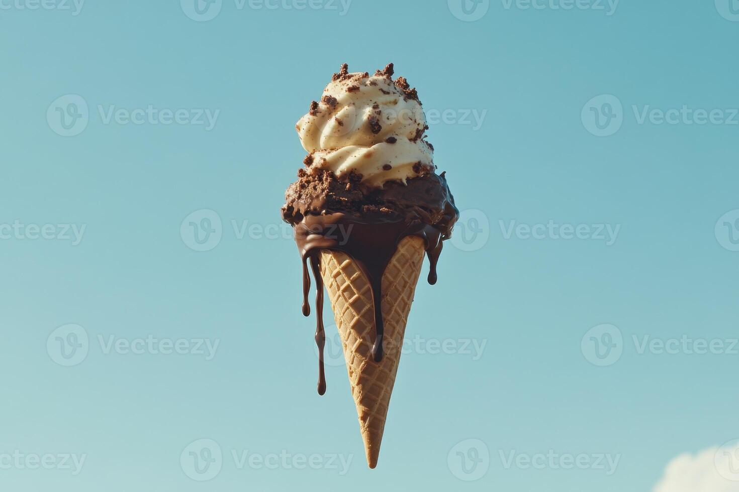 Delicious Melting Ice Cream Cone Against Blue Sky photo