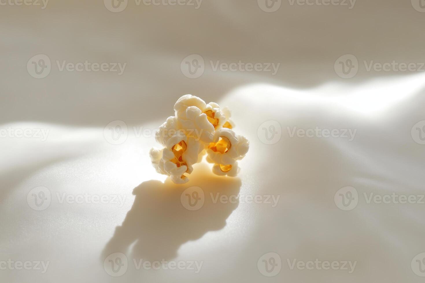 A Small Cluster Of Popcorn On A White Surface photo