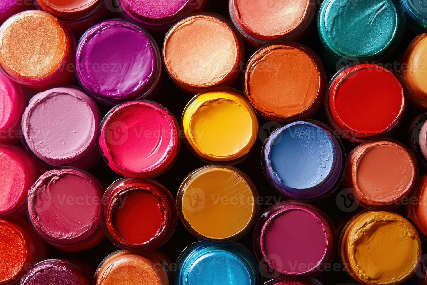 Colorful Jars Of Lip Gloss Arranged In A Pattern photo
