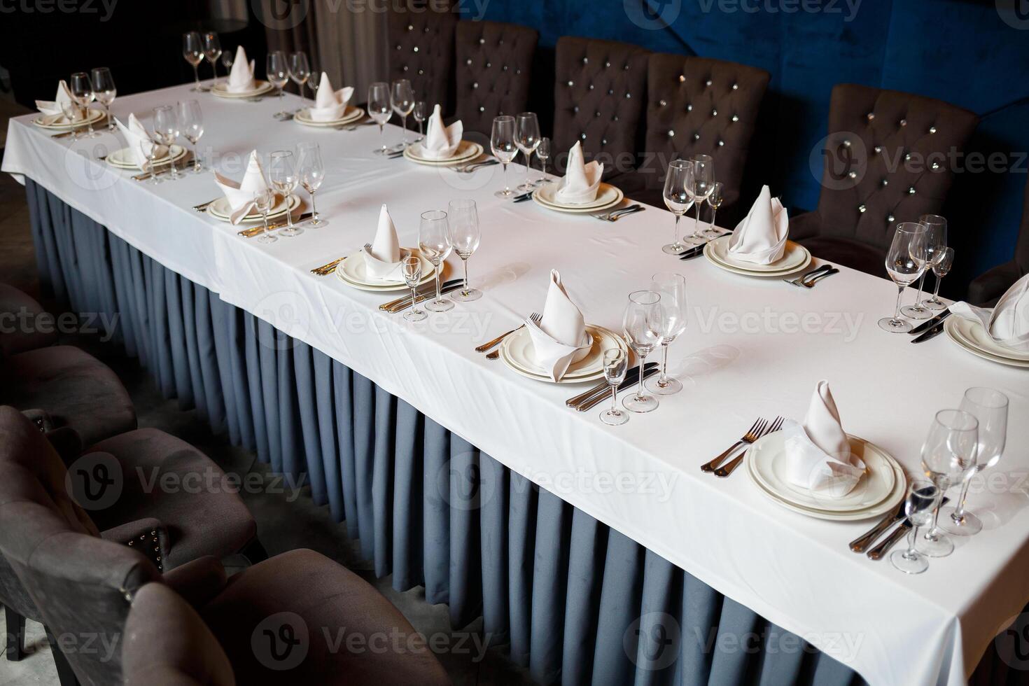 Serving a festive table in a restaurant. Preparation of a banquet for a holiday. Expensive decoration materials. Dishes for food and drinks photo