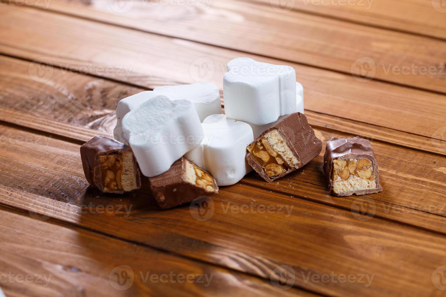 chocolate with nuts on a wooden board with marshmallows photo