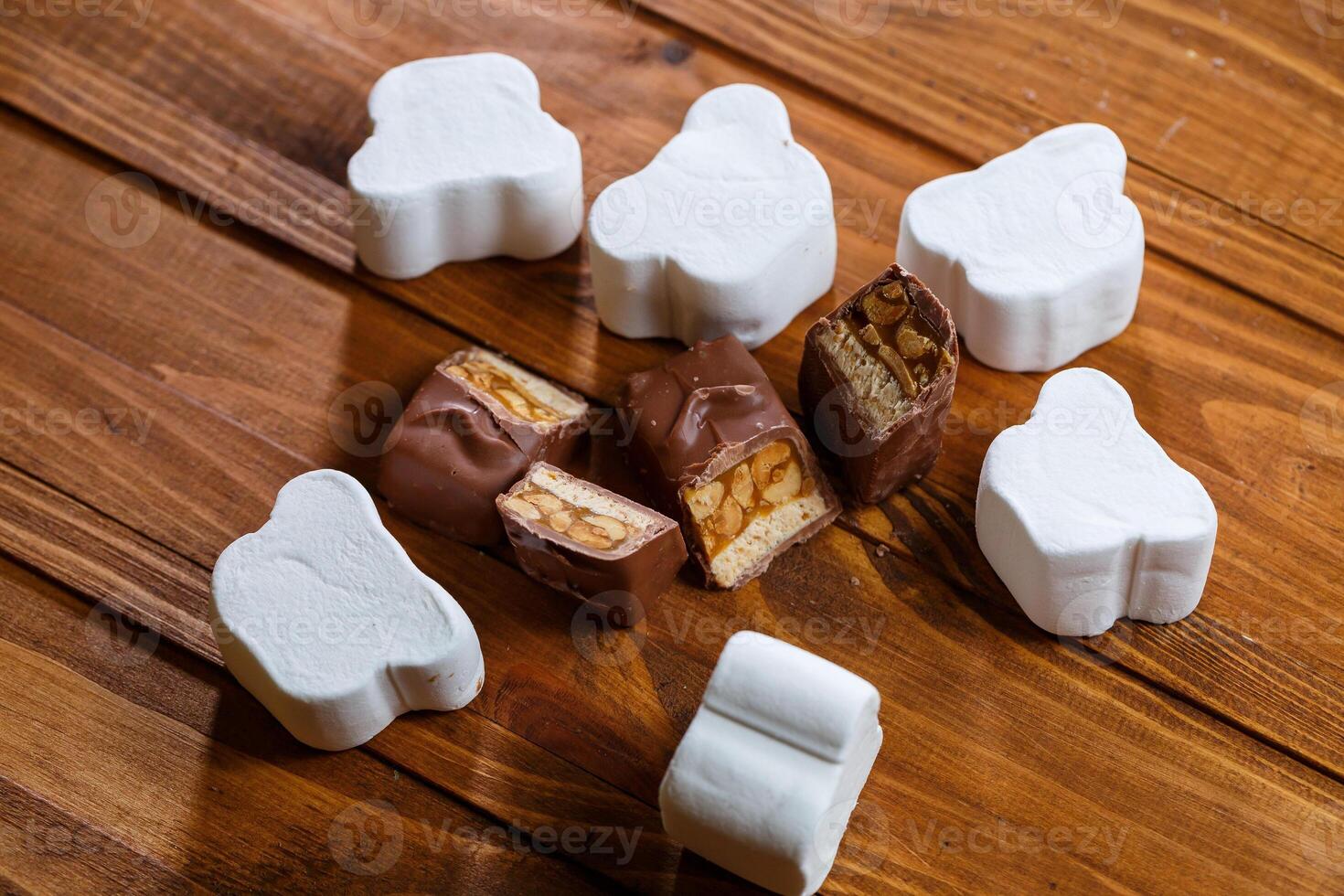 chocolate with nuts on a wooden board with marshmallows photo