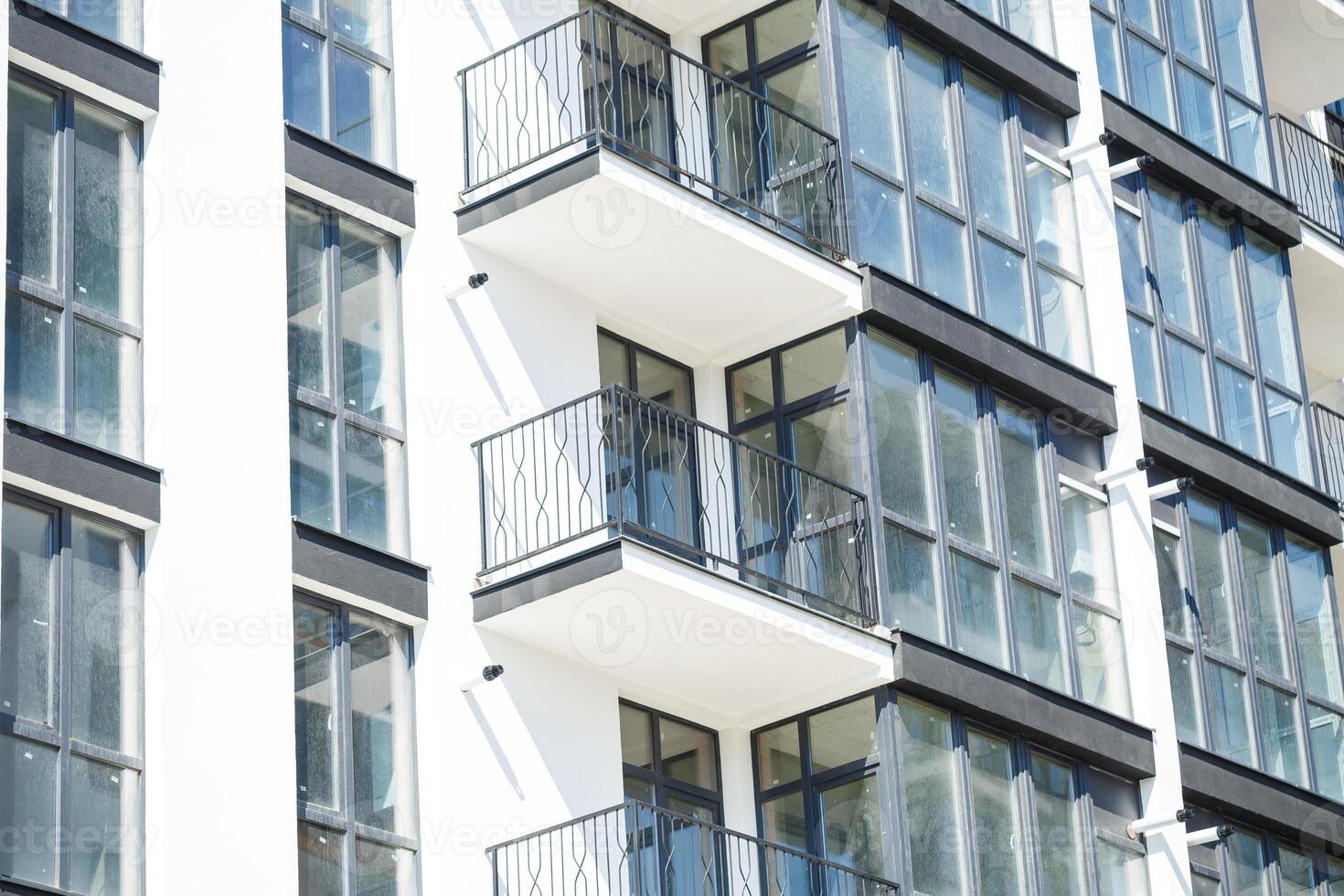 Large panoramic plastic windows. Facade of a new building in the house during construction work. Multi-storey building during construction photo