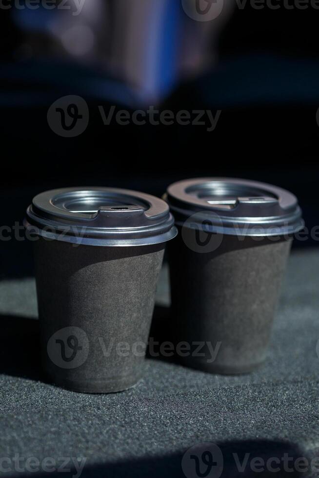 Black eco paper cups for taking coffee with you. Two cups of hot tea with a lid photo
