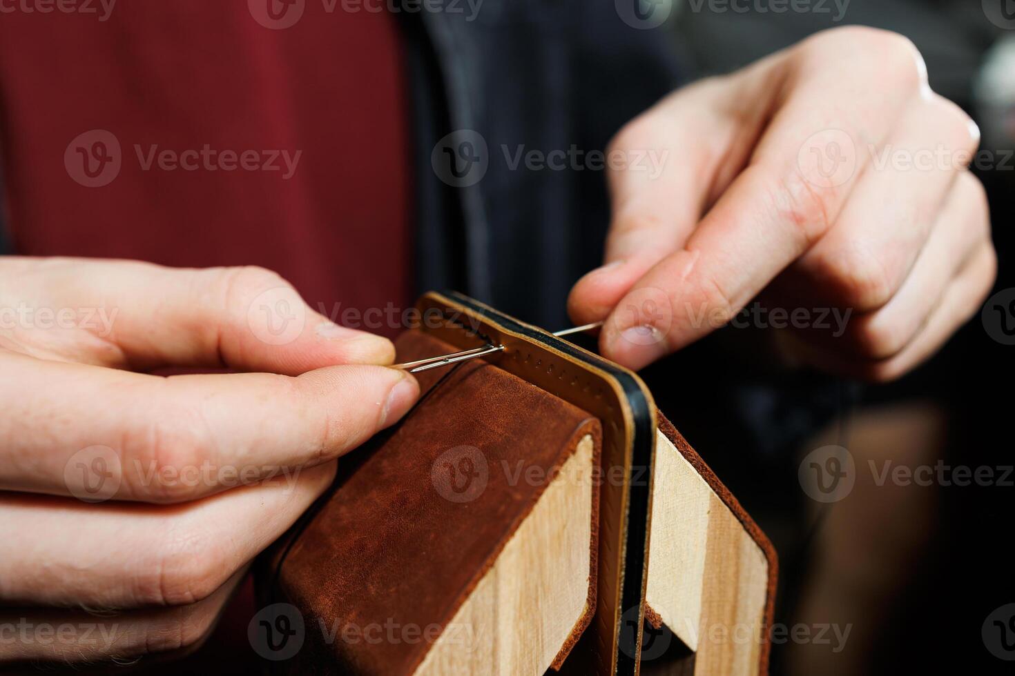 Close-up of male hands working with natural leather. Handmade products made of genuine leather. photo
