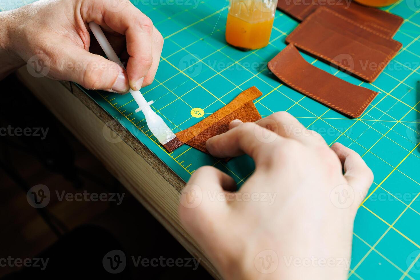 Close-up of male hands working with natural leather. Handmade products made of genuine leather. photo