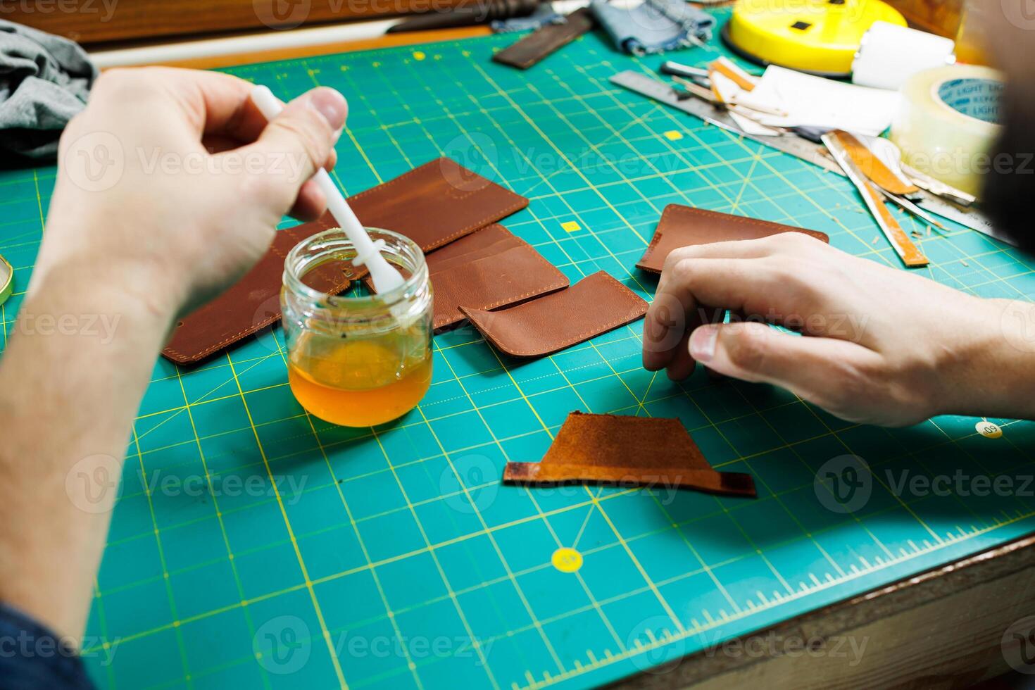 Close-up of male hands working with natural leather. Handmade products made of genuine leather. photo