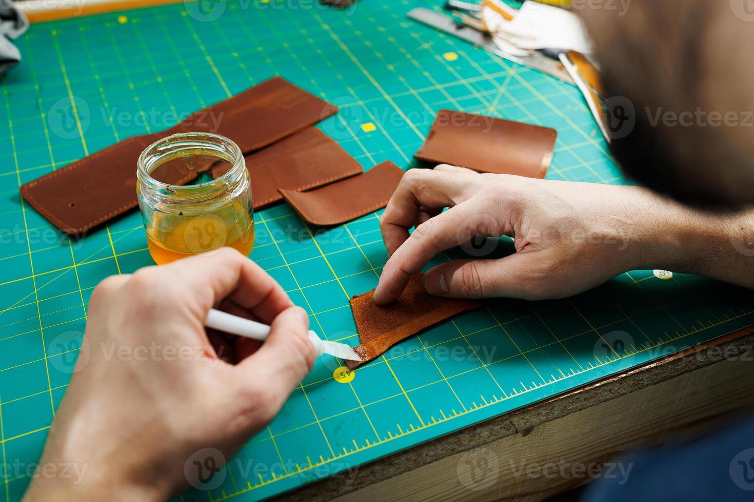 Close-up of male hands working with natural leather. Handmade products made of genuine leather. photo