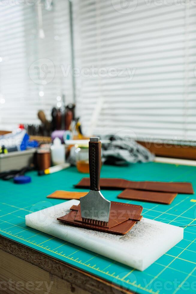 A work table for the manufacture of products from genuine leather. Tools for manual leather work photo