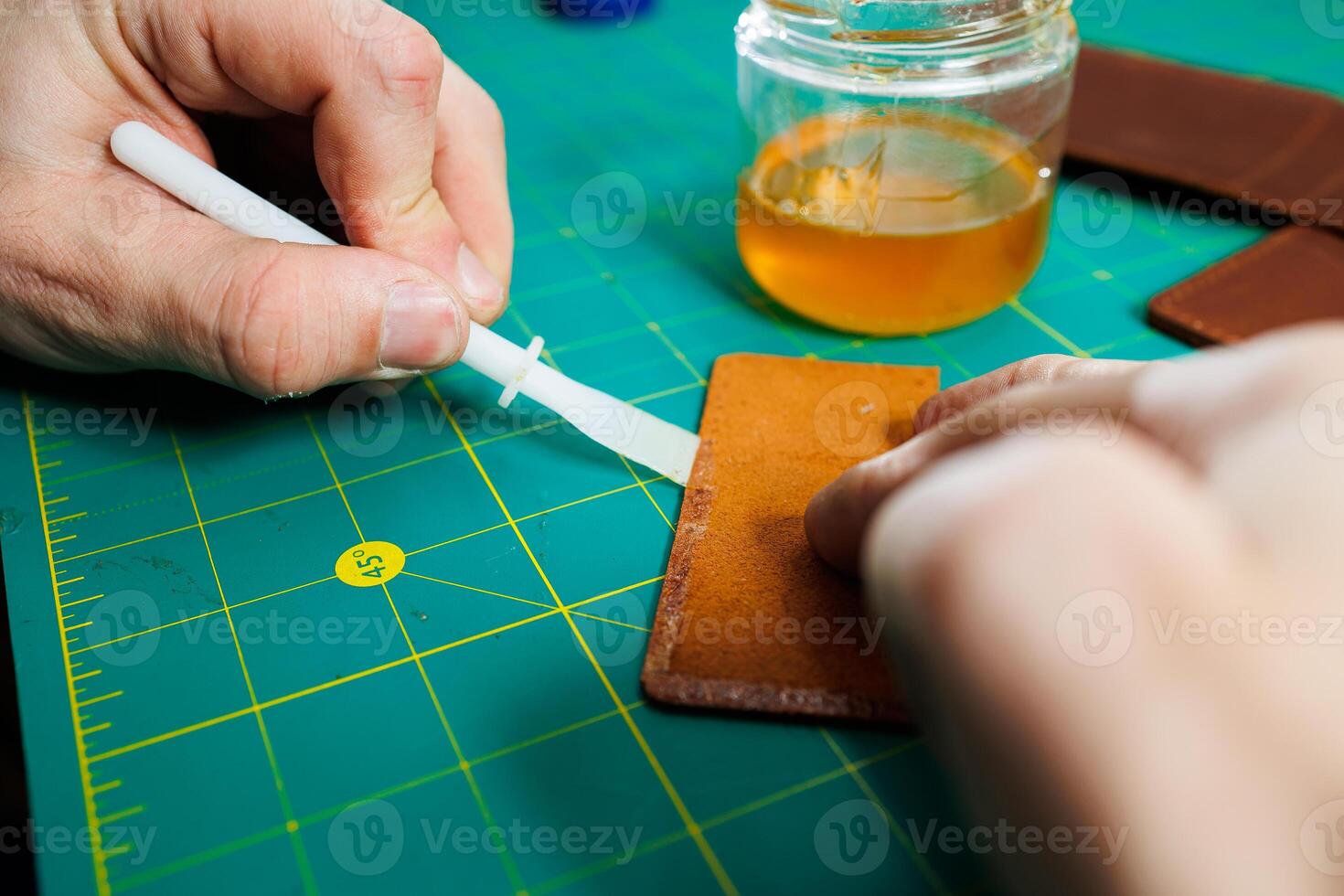 Close-up of male hands working with natural leather. Handmade products made of genuine leather. photo
