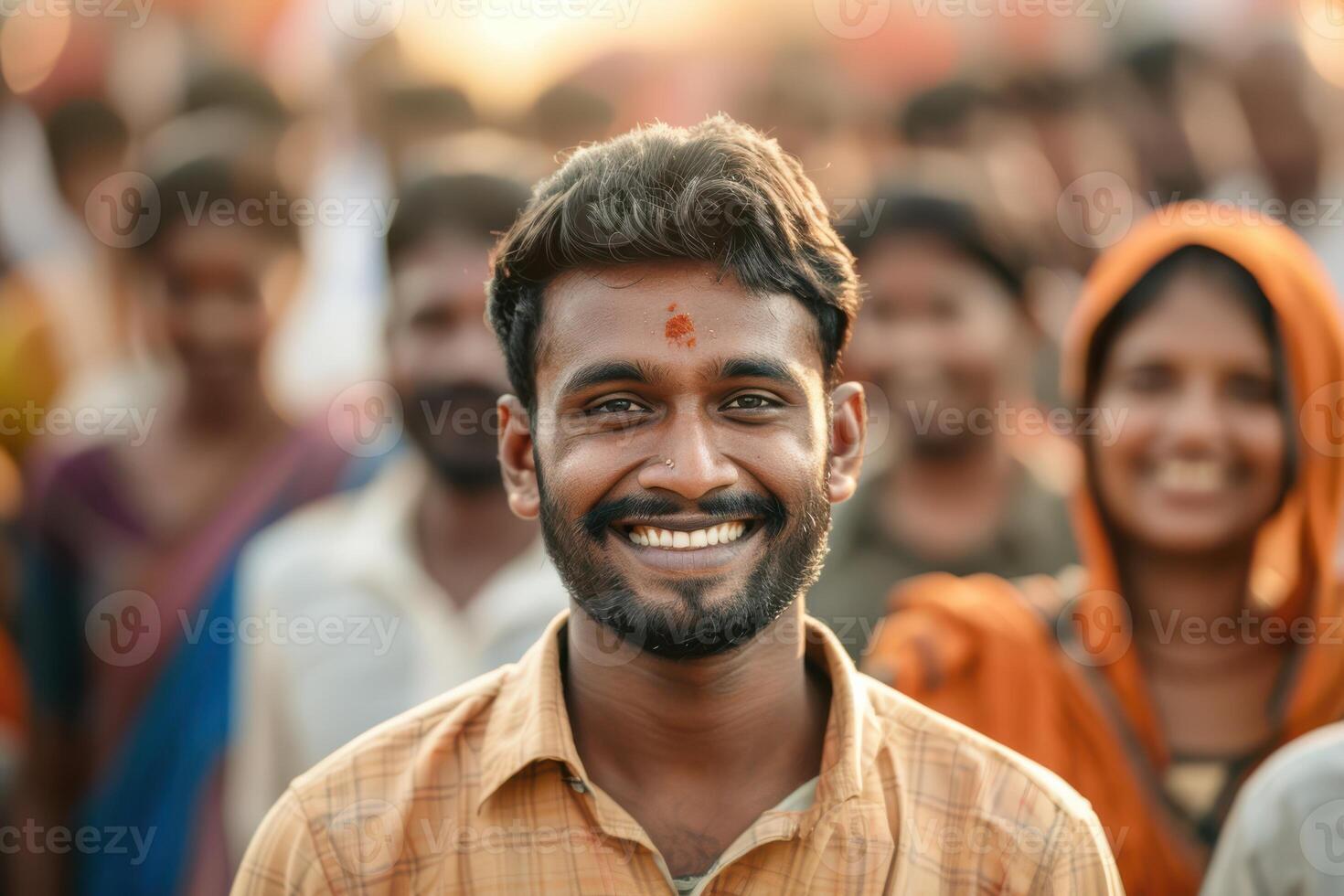 A man smiles in front of a crowd photo
