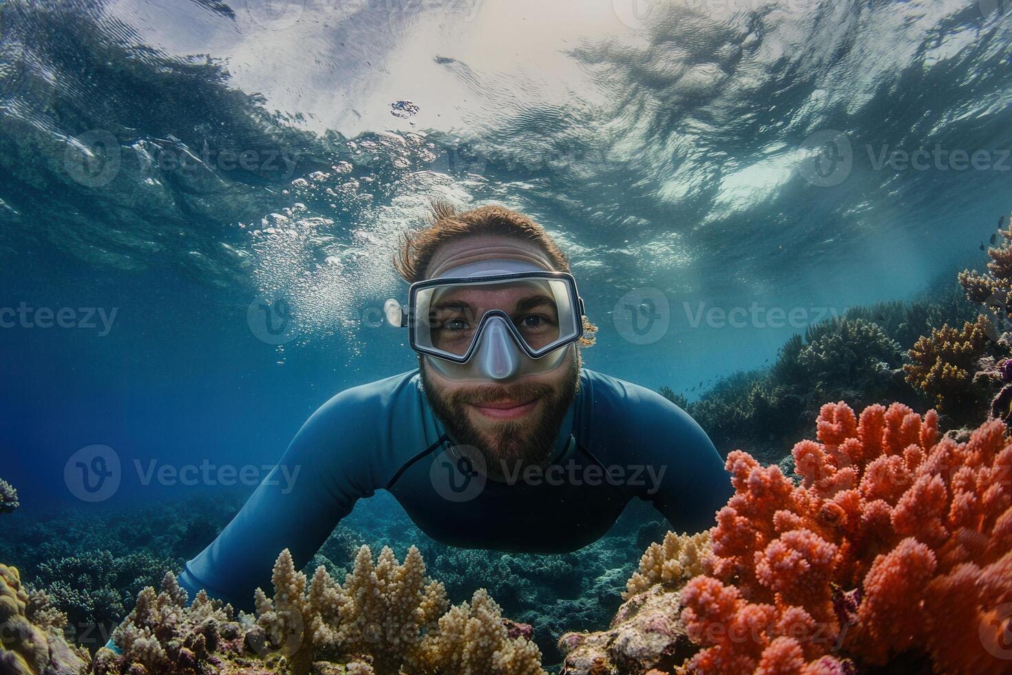 Diver smiling underwater with colorful coral reef. photo