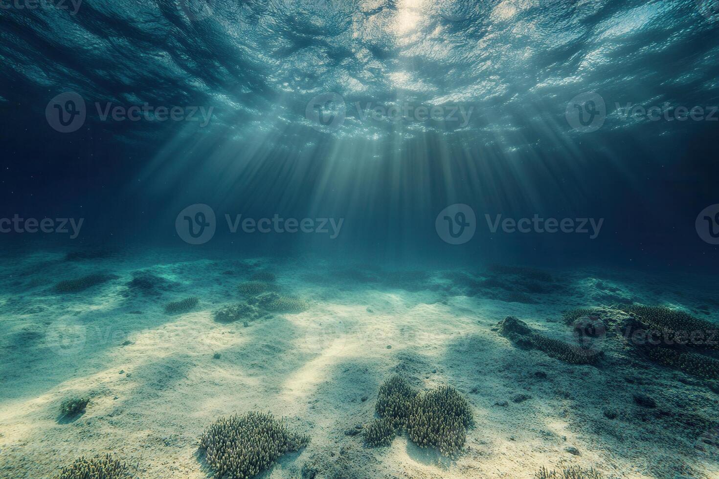 Underwater scene with rays of light and sandy seabed. photo