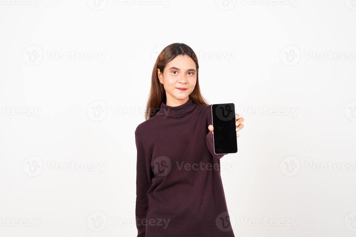 Smiling at Camera Holding Smartphone, Showing and Presenting Blank Screen for Ad Or Apps Of Beautiful Asian Woman Isolated On White Background photo