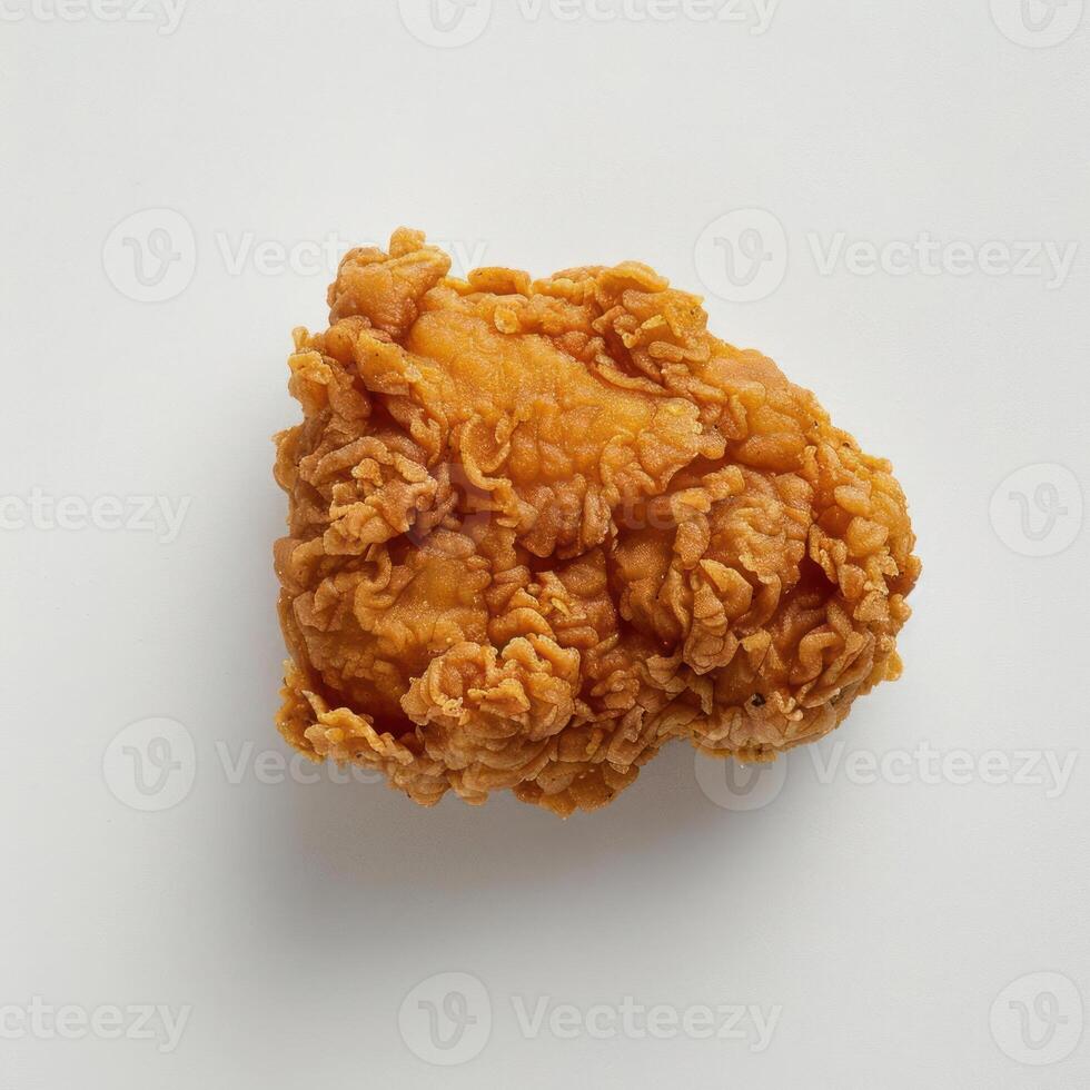 Crisp fried chicken piece with visible golden brown skin. photo