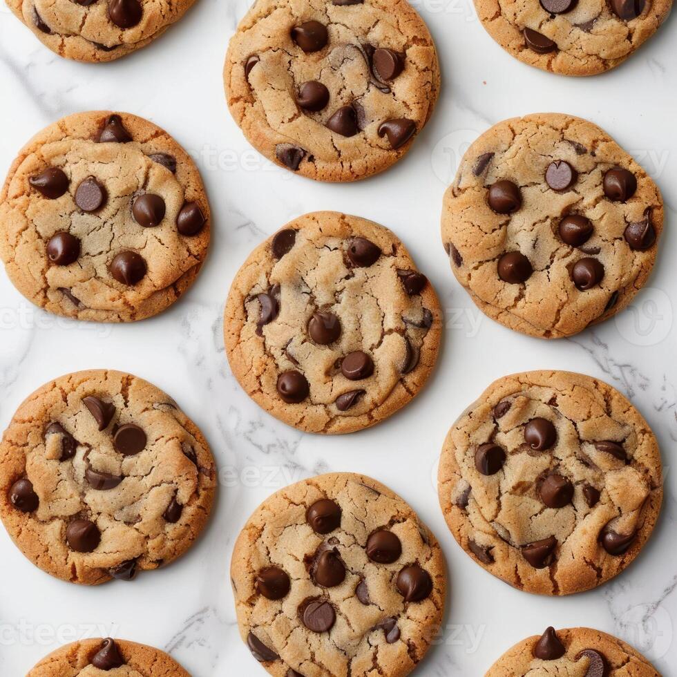 A collection of chocolate chip cookies on a white surface. photo