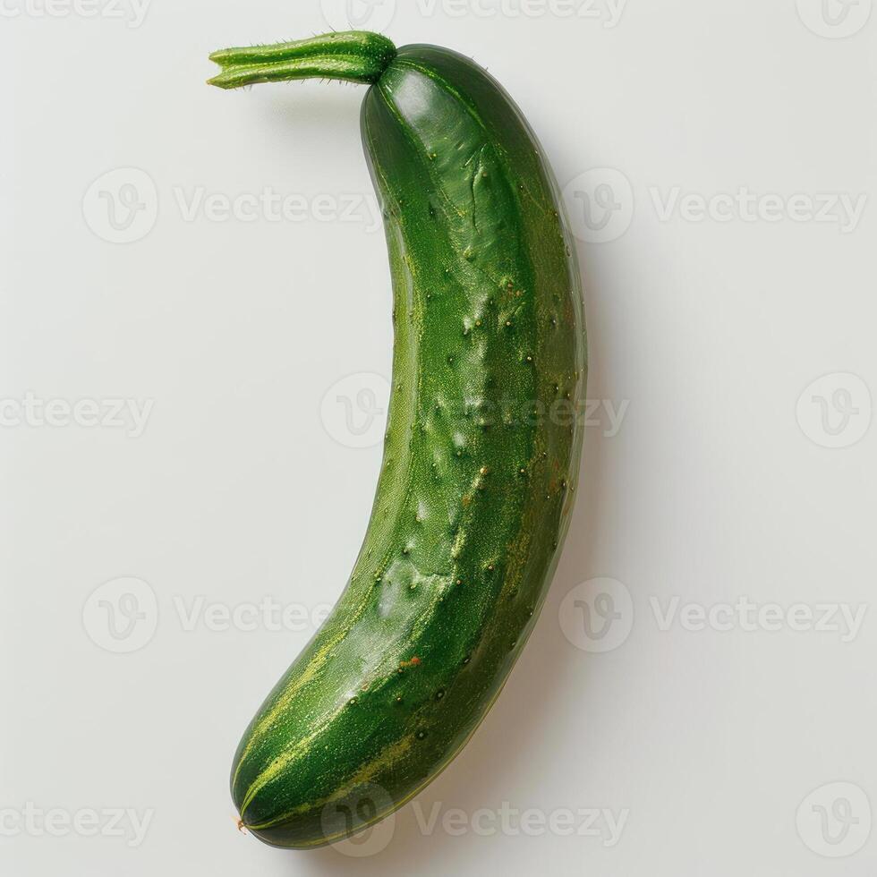 A single, whole green cucumber on a white background. photo