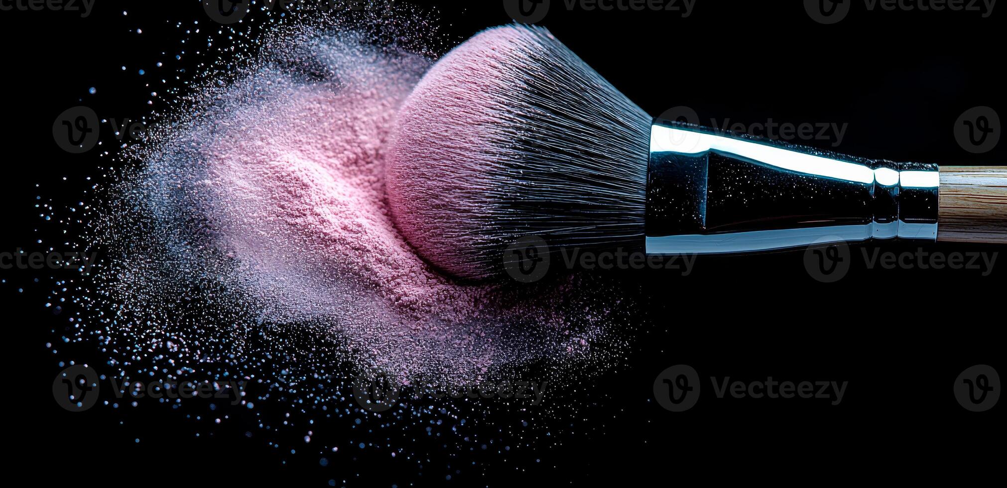 Swirling pink powder with makeup brush. A brush sweeps pink powder, releasing a cloud of cosmetics in a dark setting, highlighting beauty. photo